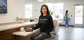 Black crewneck sweatshirt featuring "Front Desk" definition text, designed for medical receptionists and outpatient office staff.